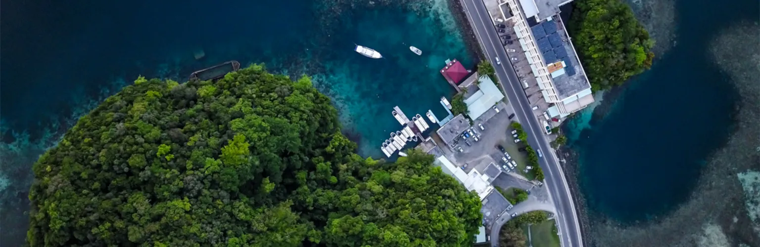 aerial photo, bird's eye view of Fish 'n Fins Palau's premier diving center in its bay at the Rock Islands