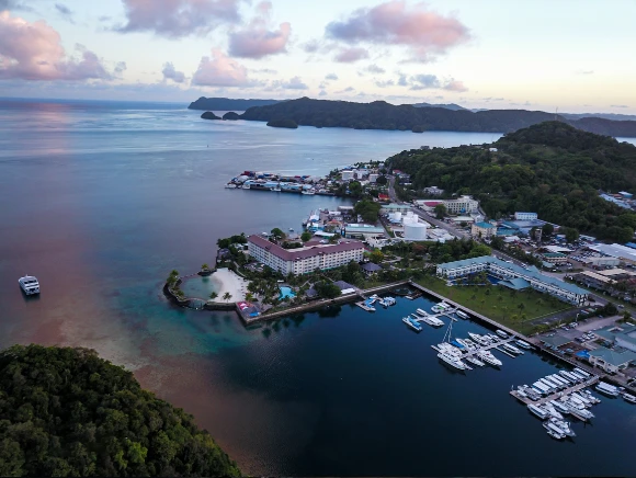 aerial photo of the yacht harbor and Palau Royal Resort shot from the Fish 'n Fins docks at sunset