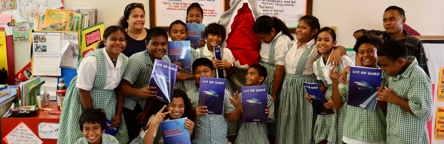 group photo of students in Palau with their shark books from Fish 'n Fins